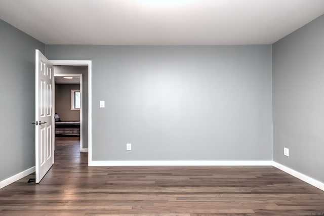 unfurnished room with dark hardwood / wood-style floors