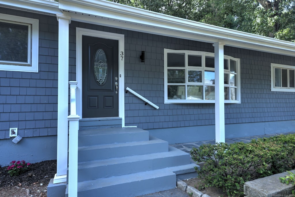 doorway to property featuring covered porch