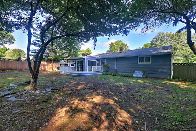 rear view of house with a wooden deck