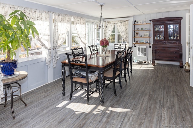 dining room with an inviting chandelier and dark hardwood / wood-style flooring