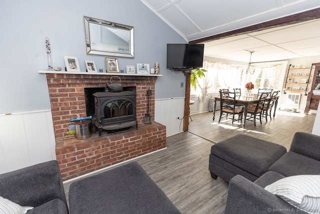 living room with wood-type flooring and a wood stove