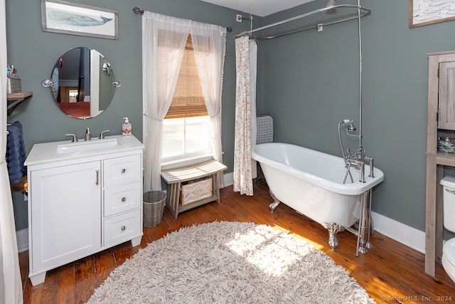 full bathroom featuring vanity, toilet, hardwood / wood-style flooring, and shower with separate bathtub