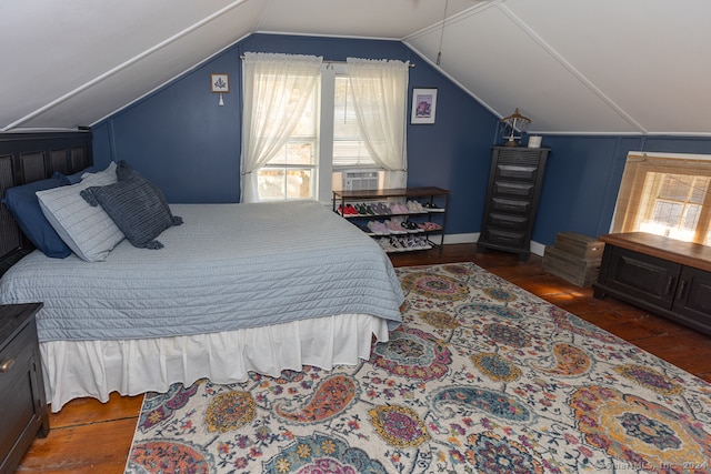 bedroom with vaulted ceiling, multiple windows, and dark hardwood / wood-style floors