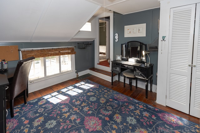 home office with vaulted ceiling and dark hardwood / wood-style flooring