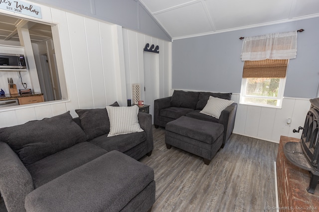 living room featuring lofted ceiling, ornamental molding, and hardwood / wood-style flooring