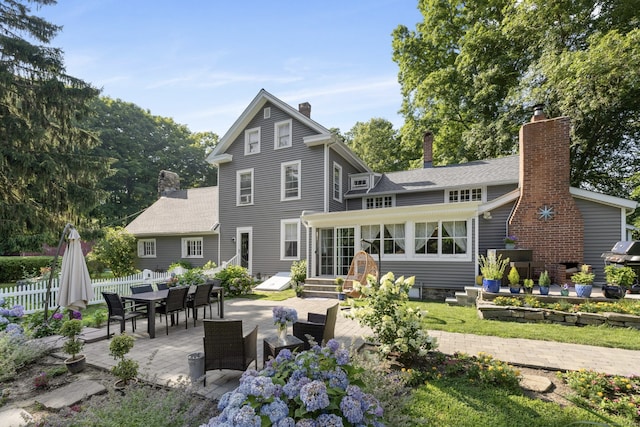 back of house with a patio