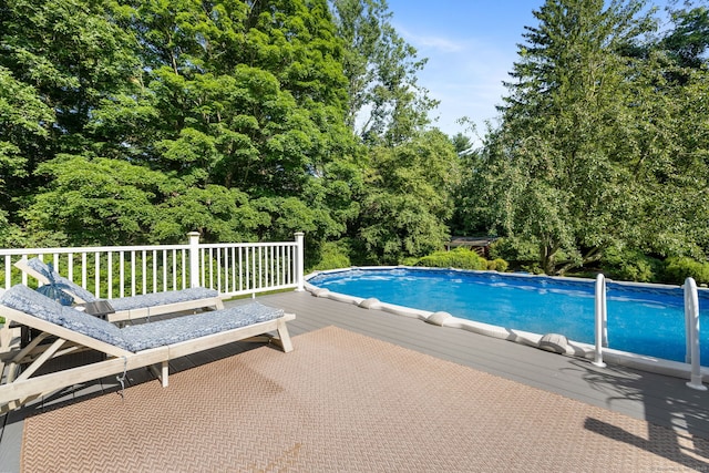 view of swimming pool featuring a deck