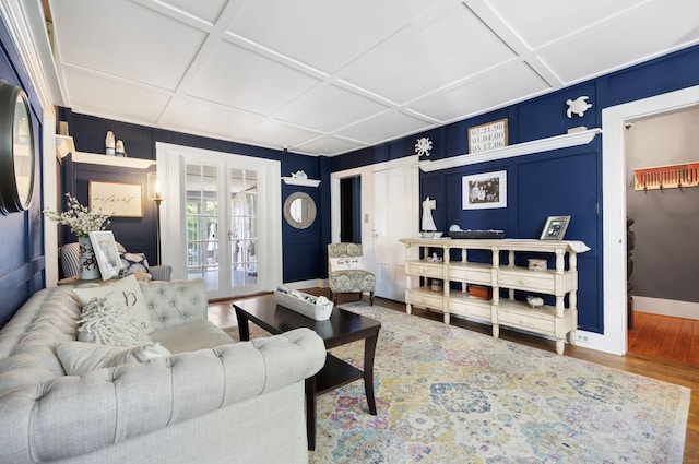 living room with french doors, hardwood / wood-style flooring, and coffered ceiling