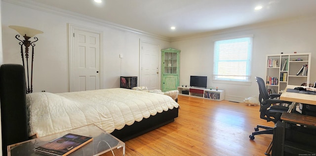bedroom featuring crown molding, recessed lighting, and wood finished floors