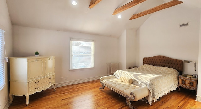 bedroom featuring visible vents, baseboards, lofted ceiling with beams, and light wood-style floors