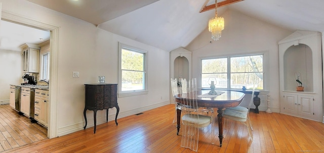 dining space with visible vents, light wood-style flooring, lofted ceiling with beams, baseboards, and a chandelier