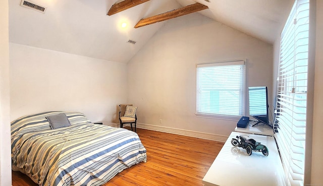 bedroom featuring visible vents, wood finished floors, and vaulted ceiling with beams