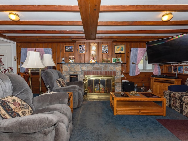 living room with a fireplace, dark carpet, beamed ceiling, and wood walls