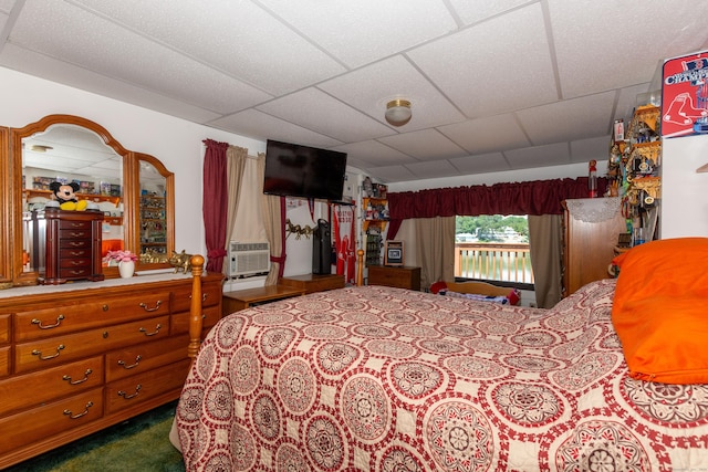 bedroom featuring carpet, a drop ceiling, and cooling unit