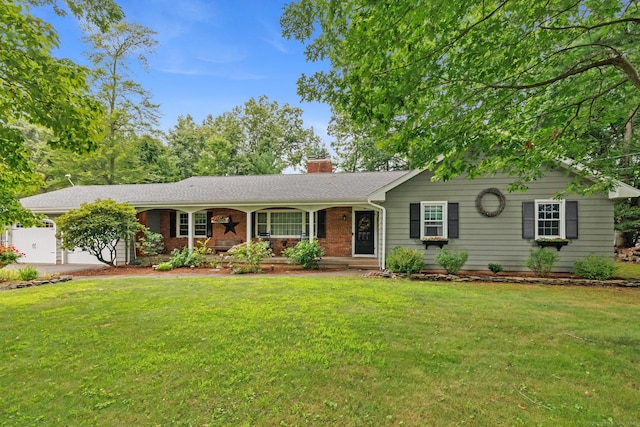 ranch-style house with a garage and a front lawn