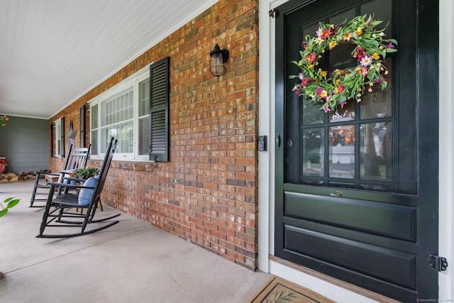 view of exterior entry with covered porch