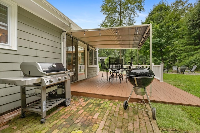 wooden terrace featuring a lawn and a pergola