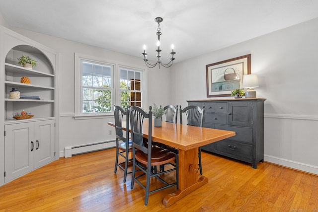 dining area featuring a baseboard heating unit, an inviting chandelier, built in features, and light hardwood / wood-style floors