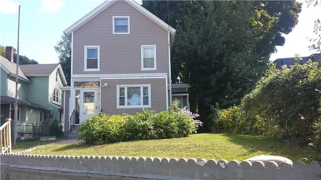 back of house with a lawn