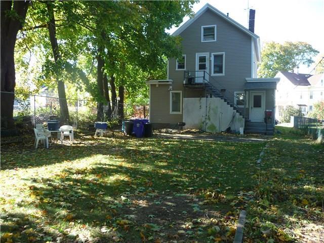 back of house with a lawn