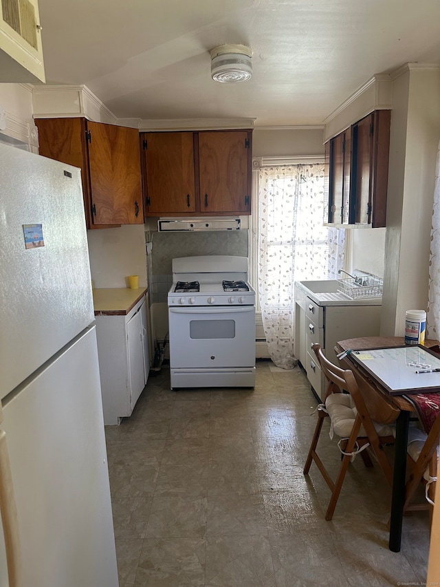 kitchen featuring ventilation hood, white appliances, and tile patterned floors