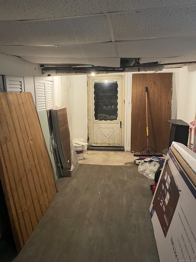 basement featuring hardwood / wood-style flooring and a drop ceiling