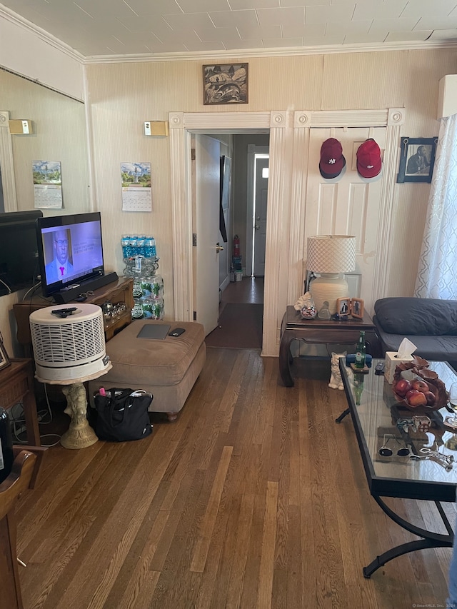 living room featuring dark hardwood / wood-style flooring and ornamental molding