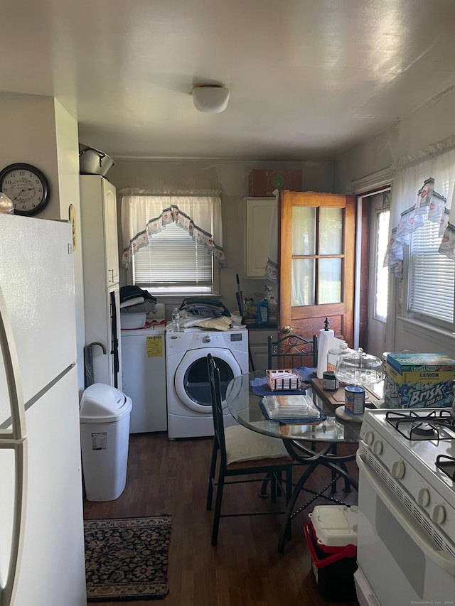 kitchen with washer / clothes dryer, dark hardwood / wood-style floors, and white appliances