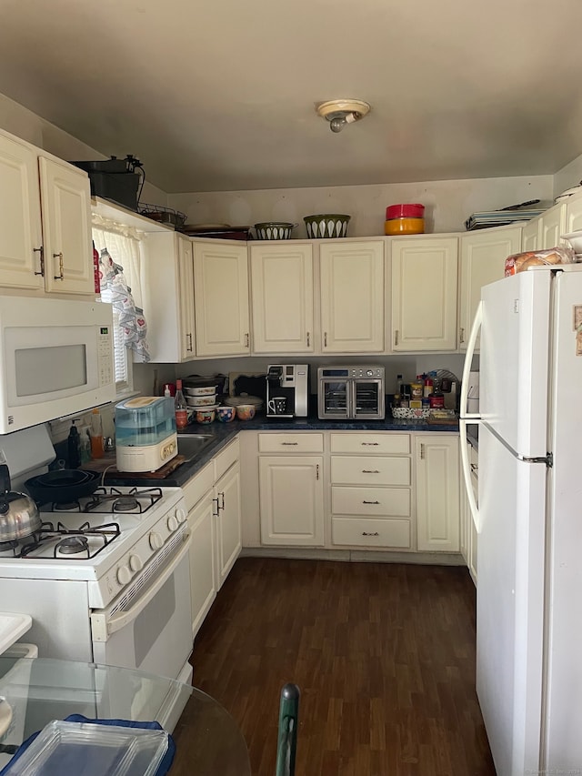 kitchen featuring white cabinetry, dark hardwood / wood-style flooring, and white appliances