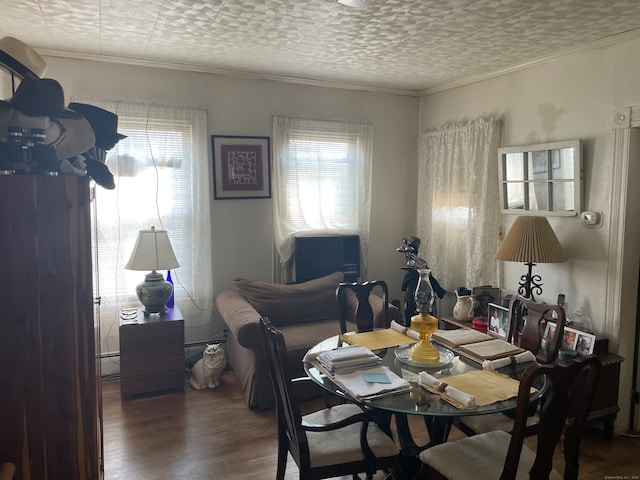 dining space featuring a baseboard heating unit, hardwood / wood-style flooring, and cooling unit