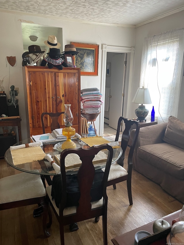 dining space with wood-type flooring