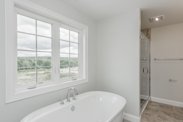 bathroom featuring shower with separate bathtub, tile patterned floors, and a wealth of natural light