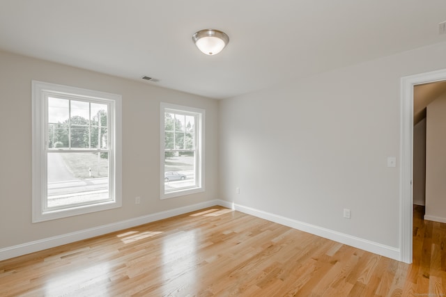 spare room with light wood-type flooring