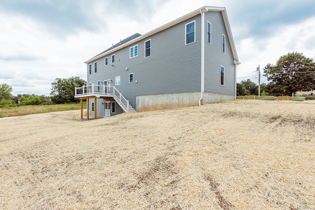 rear view of house with a wooden deck