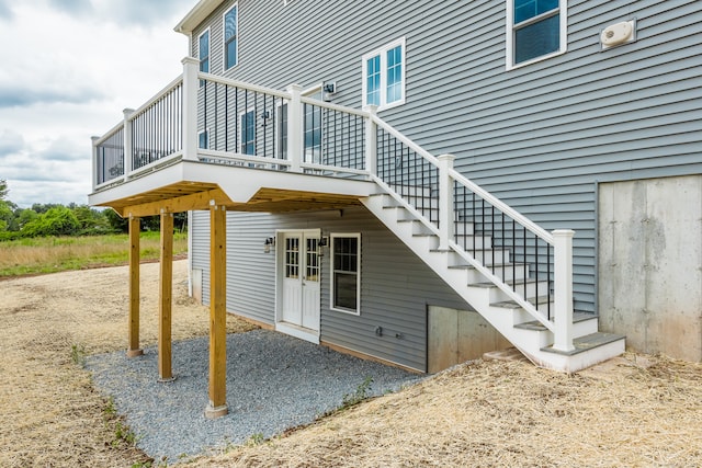 rear view of property featuring a wooden deck