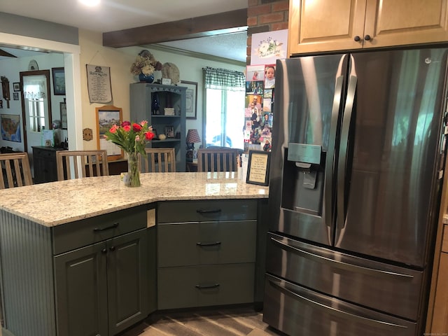 kitchen with gray cabinetry, hardwood / wood-style floors, light stone counters, crown molding, and stainless steel fridge with ice dispenser