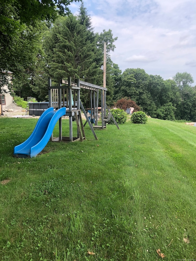 view of jungle gym featuring a lawn