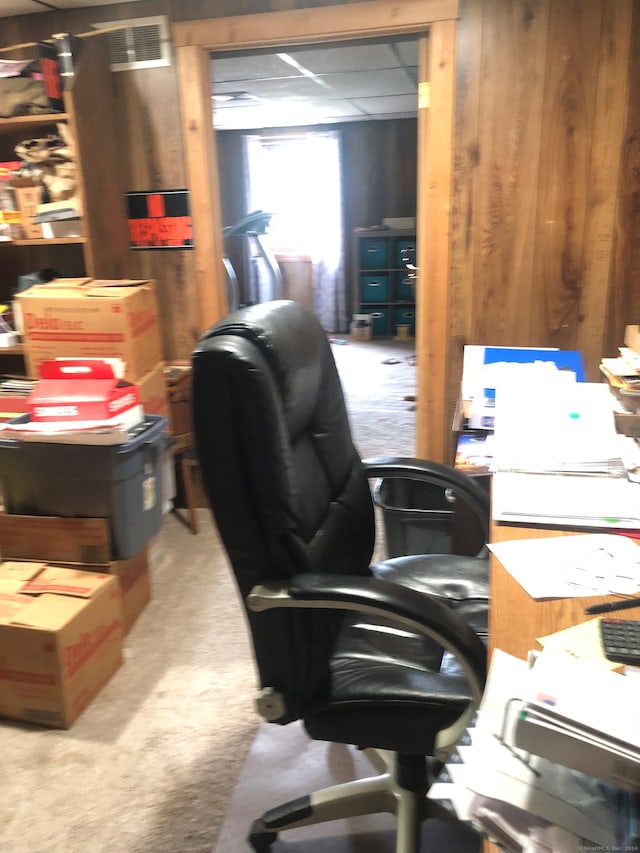 home office with wood walls and carpet flooring