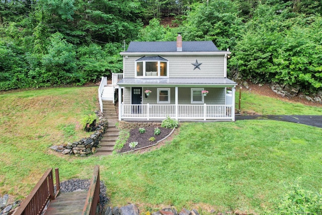 view of front of house with covered porch and a front yard