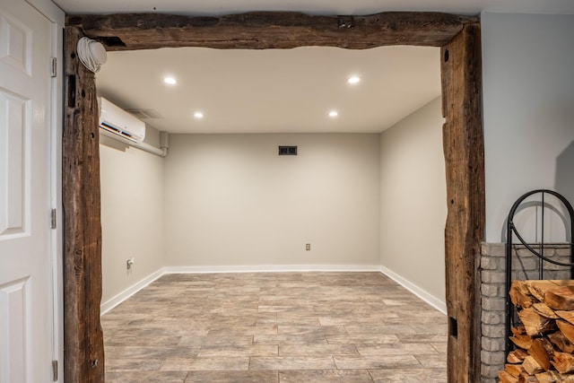 interior space featuring light hardwood / wood-style flooring and a wall mounted air conditioner