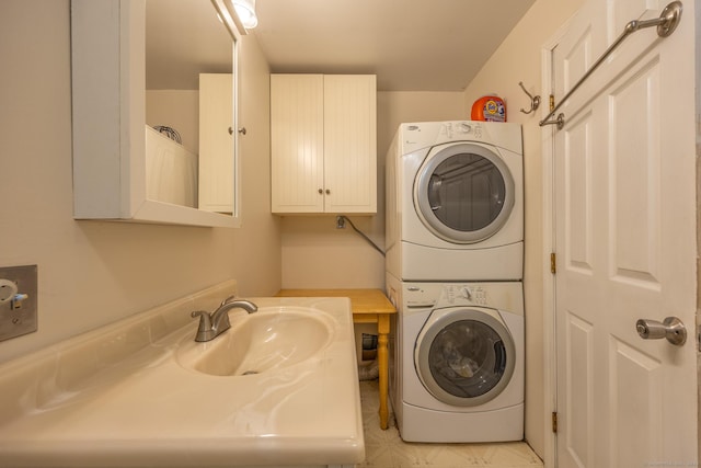 washroom with stacked washer / dryer and sink