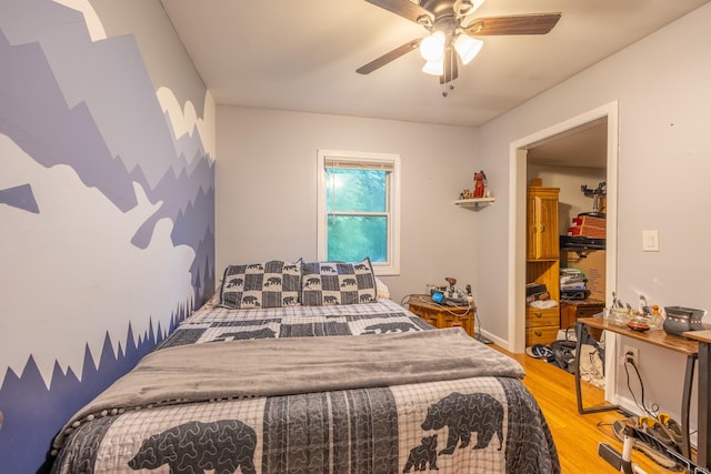 bedroom featuring light hardwood / wood-style floors and ceiling fan