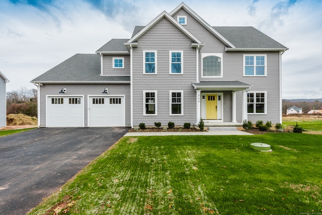 view of front facade with a garage and a front lawn