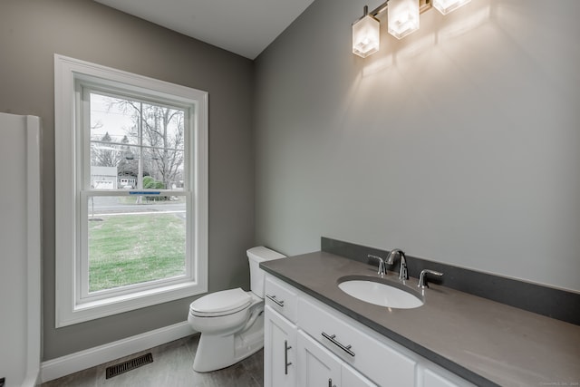 bathroom with toilet and vanity