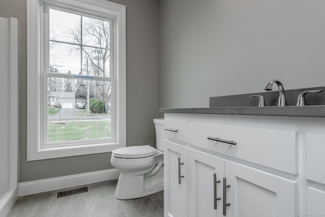 bathroom with tile patterned flooring, toilet, and vanity