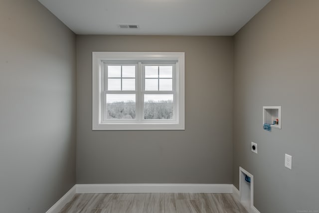 clothes washing area with hookup for a washing machine and hookup for an electric dryer