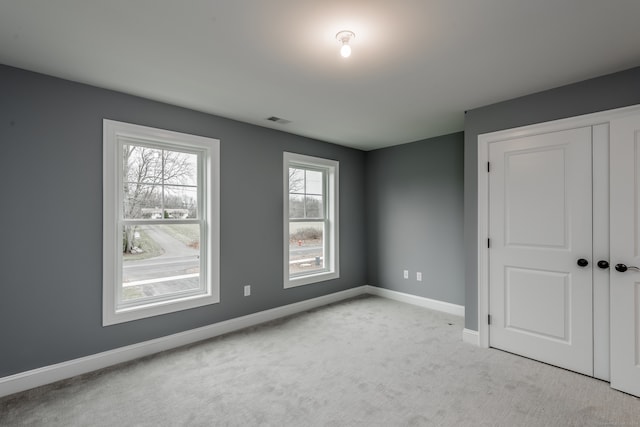 unfurnished bedroom featuring a closet and carpet flooring