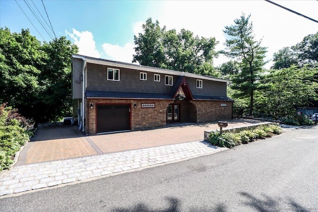 view of front facade featuring central AC and a garage