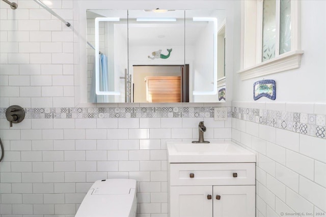 bathroom with a shower, vanity, and tile walls