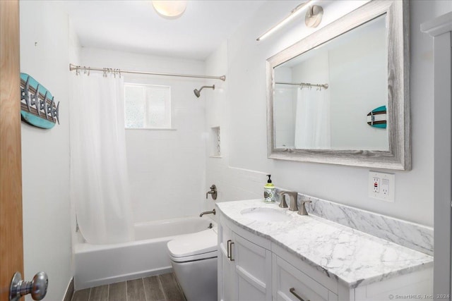 full bathroom featuring shower / bath combo, vanity, and toilet